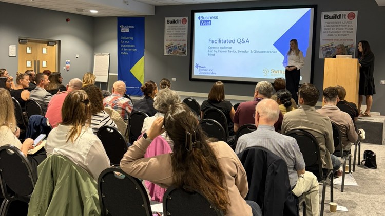 Q&A at Swindon Mindful Employer Network event. Image shows audience and three speakers on stage.