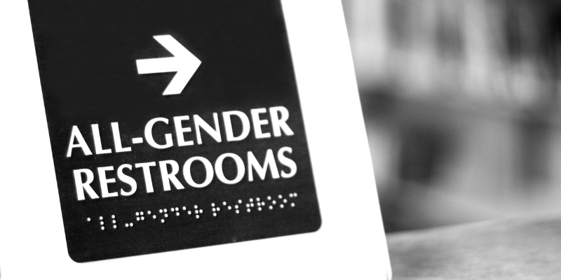 sign pointing to an all-gender bathroom