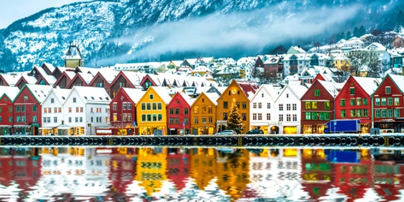 Nordic village by a lake surrounded by snow