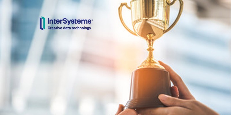InterSystems Creative Data Technology logo in front of image of a trophy being held