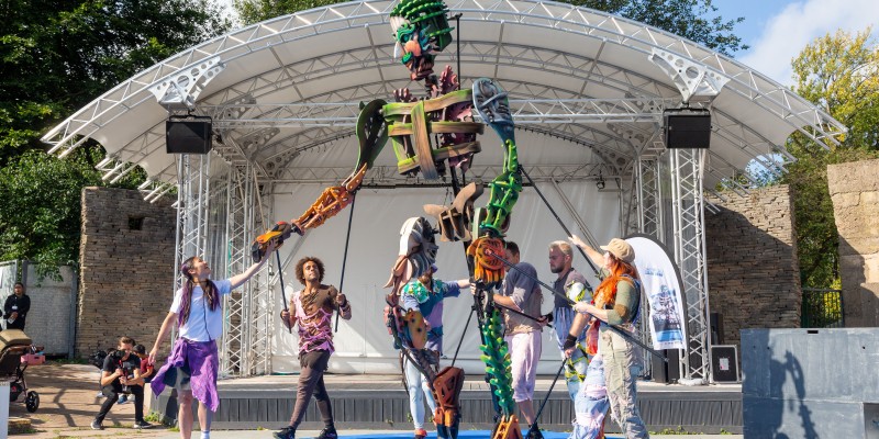 Group of people puppeteering a large puppet